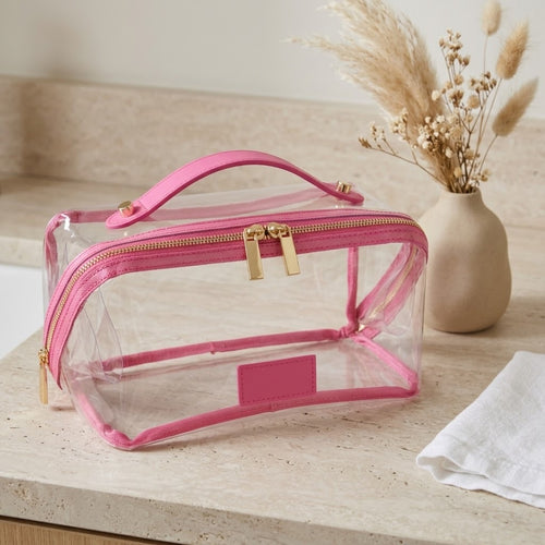 Clear flat lay makeup bag with pink trim
