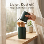 Dark green brush holder with lid keeps dust off the bristles