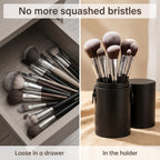 Brushes stand upright in the black brush holder