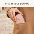 Pink lipstick case slipping into a coat pocket