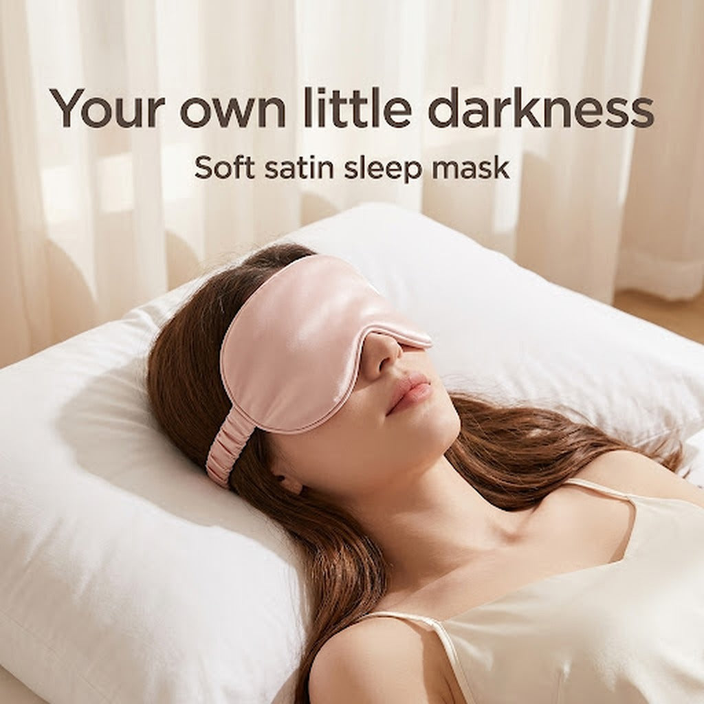 Pink satin sleep mask worn in bed
