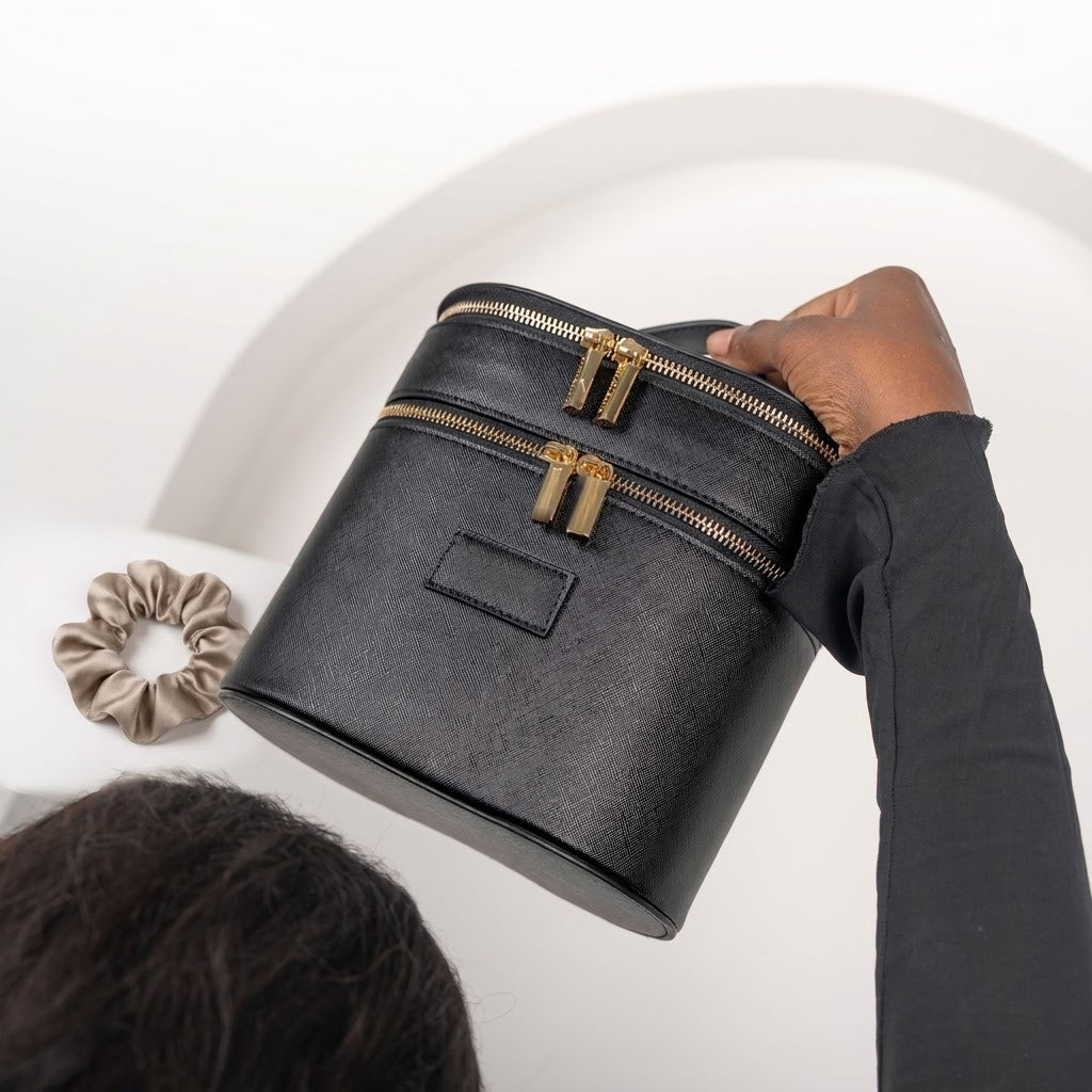 Oval vanity train case black in hand