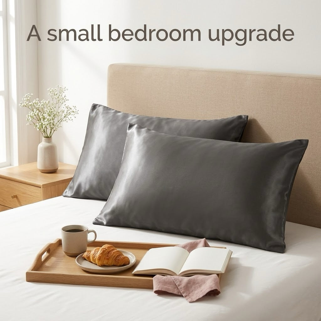 Dark grey satin pillowcases on a bed with a breakfast tray